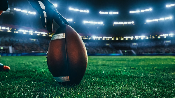 American football on pitch ready to be kicked