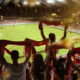 Football fans cheering at stadium