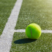Tennis ball near line on court
