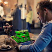 man trading on laptop and phone