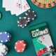 online casino on phone on table next to casino chips and cards