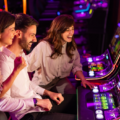 group of friends playing slot machines
