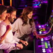 group of friends playing slot machines