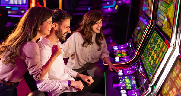 group of friends playing slot machines