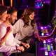 group of friends playing slot machines
