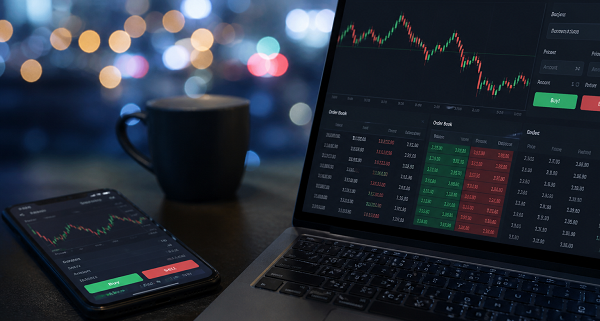 trading on laptop and phone