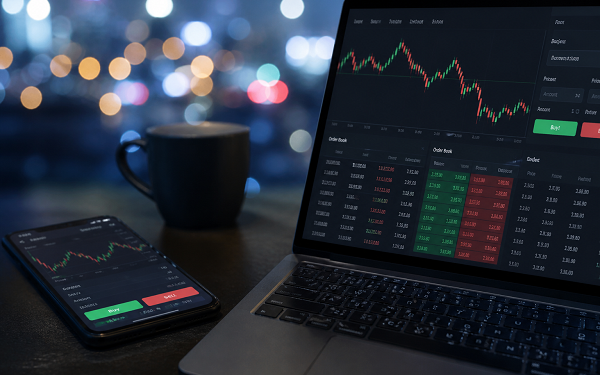 trading on laptop and phone