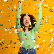 woman celebrating win with confetti falling down