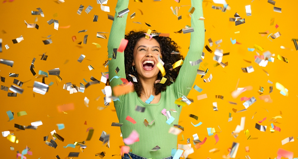 woman celebrating win with confetti falling down