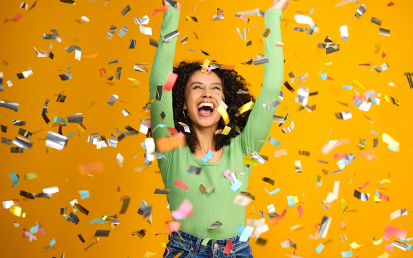 woman celebrating win with confetti falling down